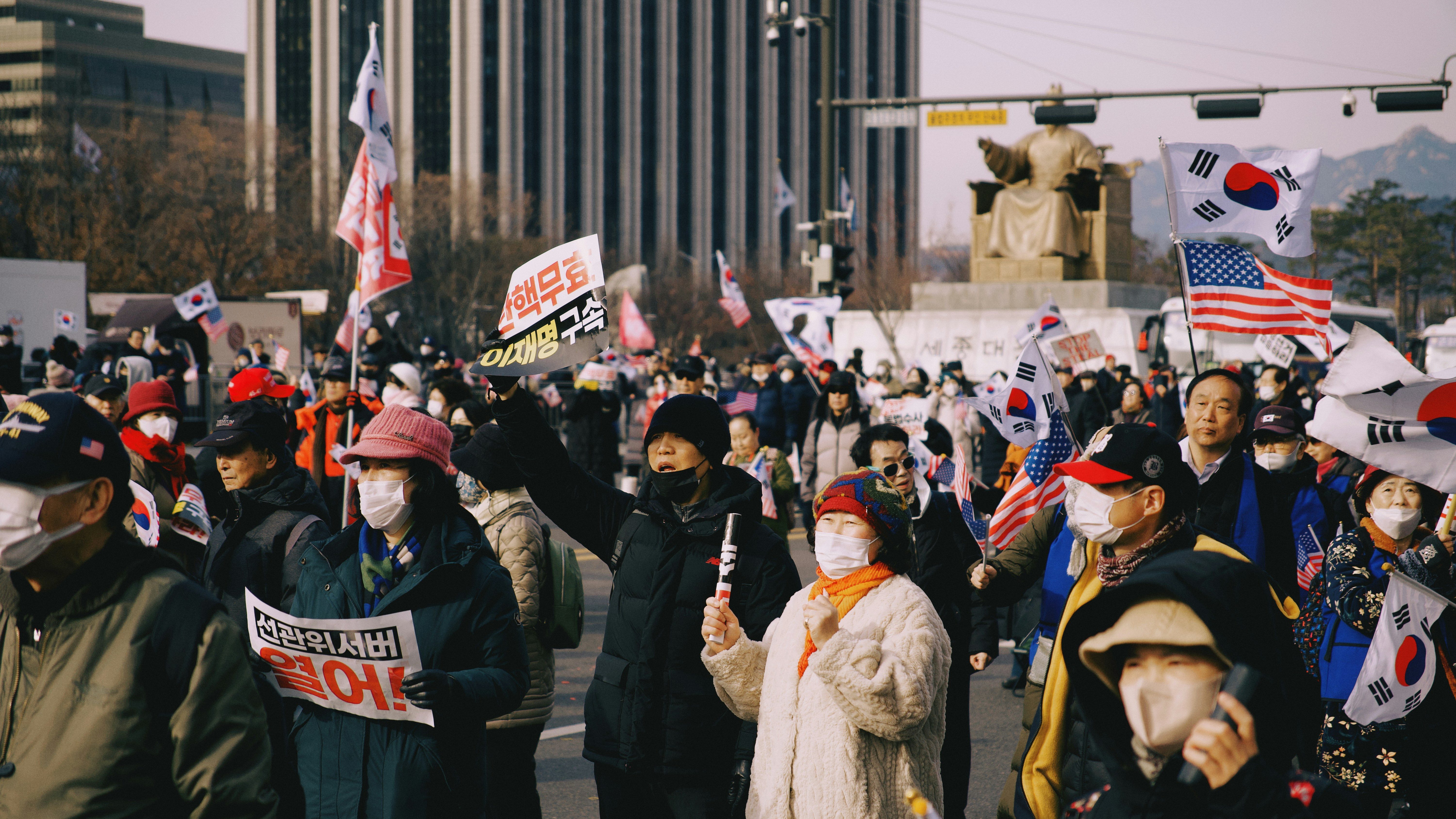 People are protesting in a large crowd.