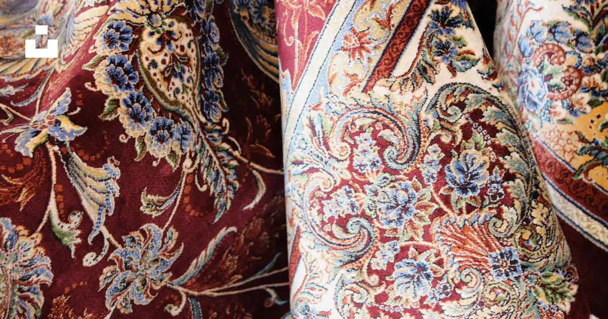 Here is a short caption for the image: a rolled, richly patterned red ...