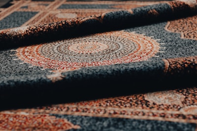 Rolled-up rug shows intricate pattern and detail.