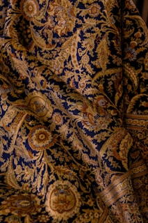 The fabric shows intricate paisley patterns.