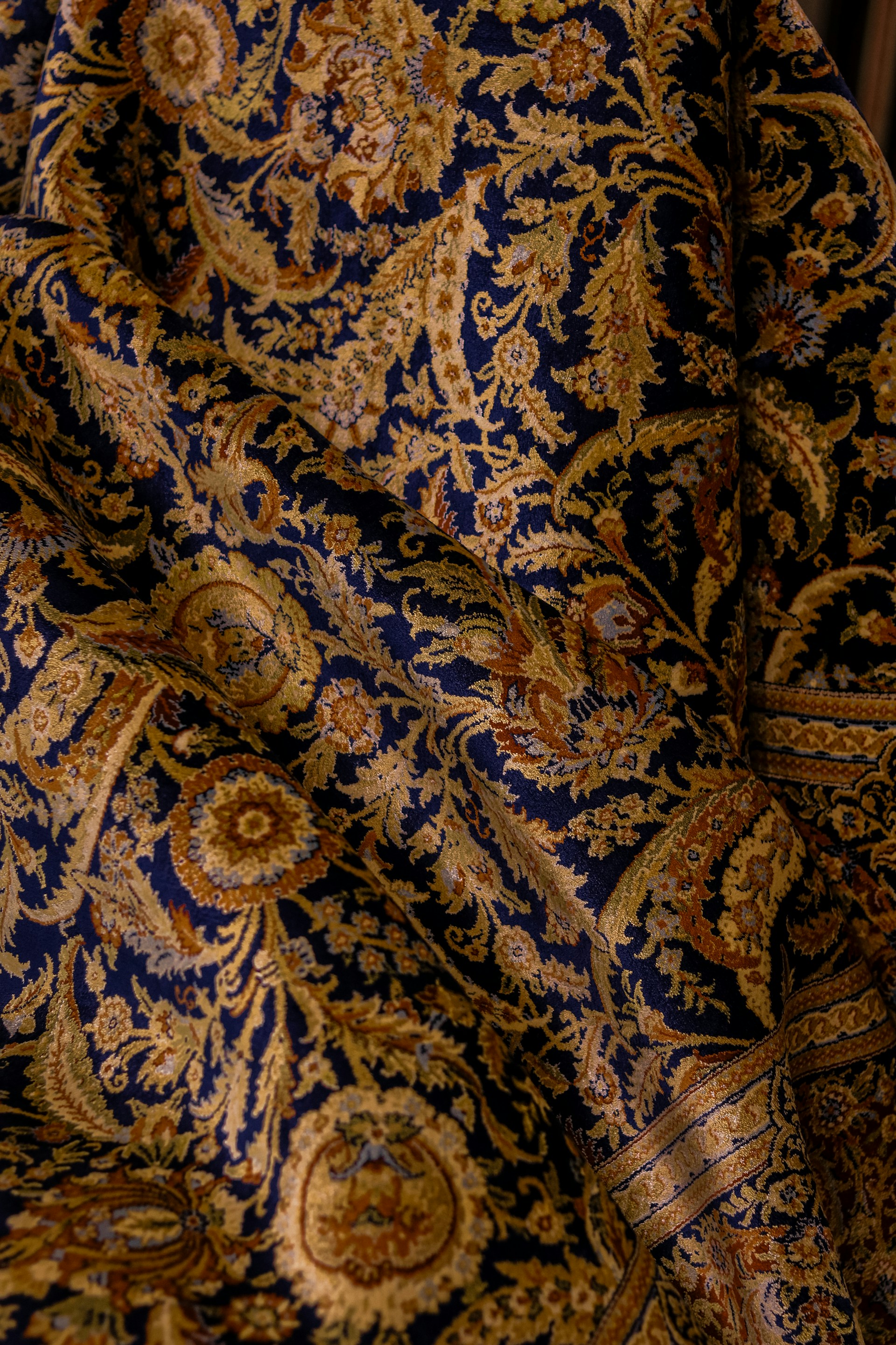 The fabric shows intricate paisley patterns.