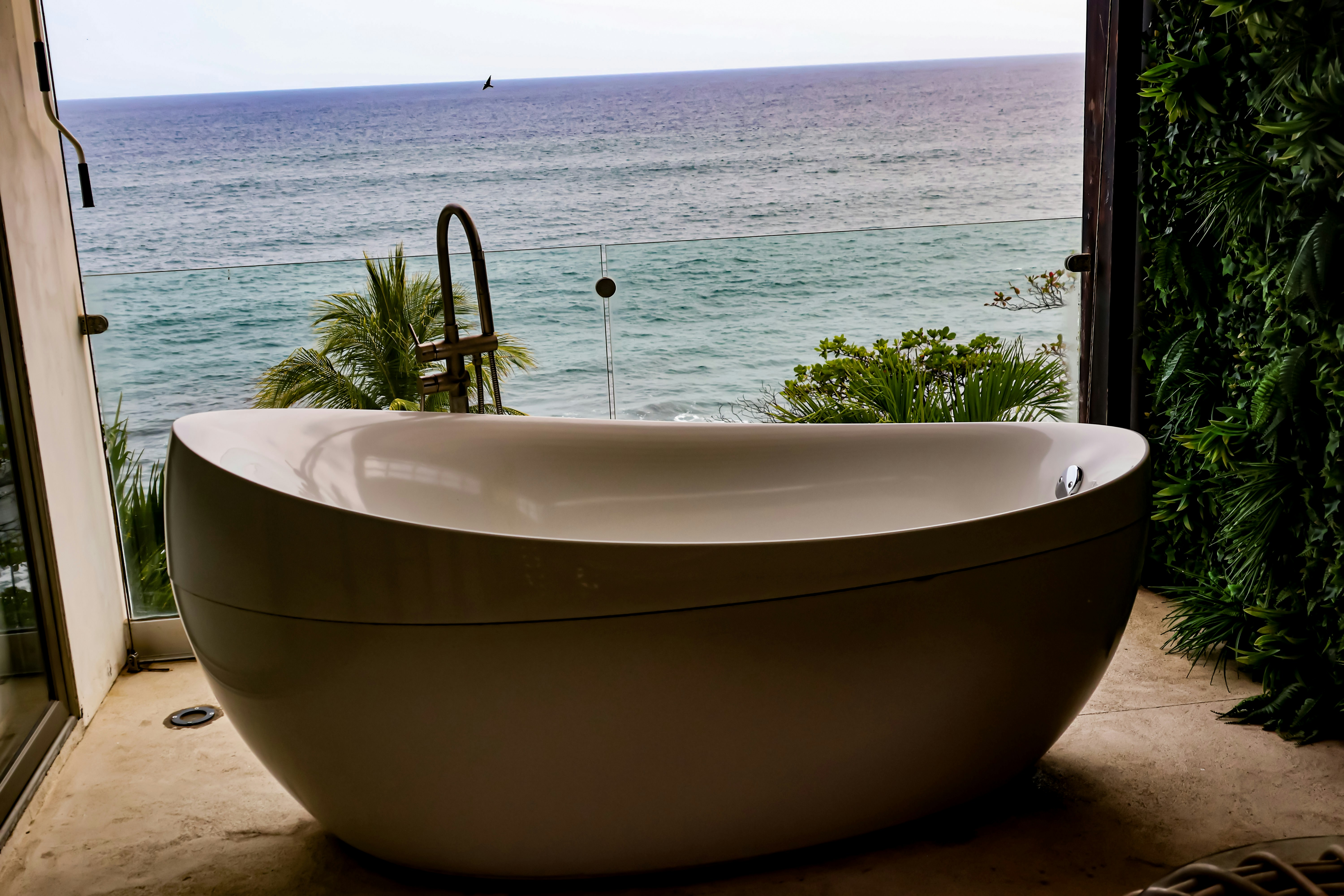 A bathtub overlooks the sea, the perfect spot to enjoy royalty free bathtub chill music