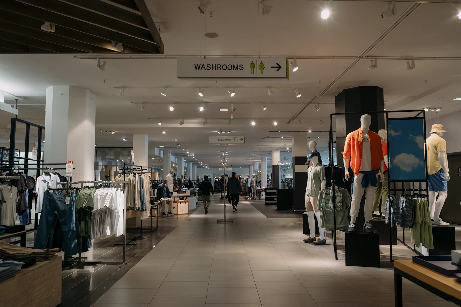 Clothes on display racks inside a department store