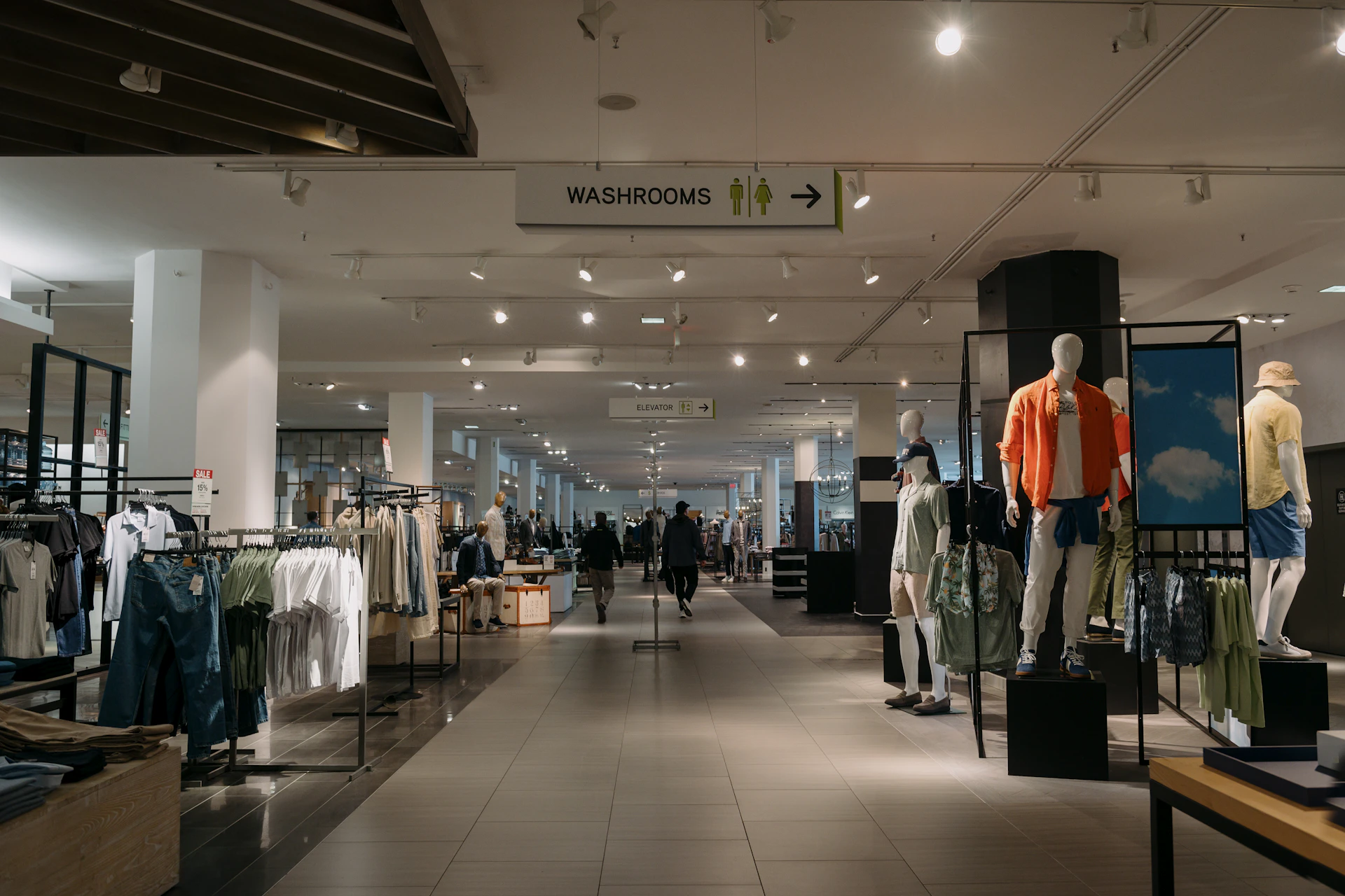 Inside of a department store with clothes on display.