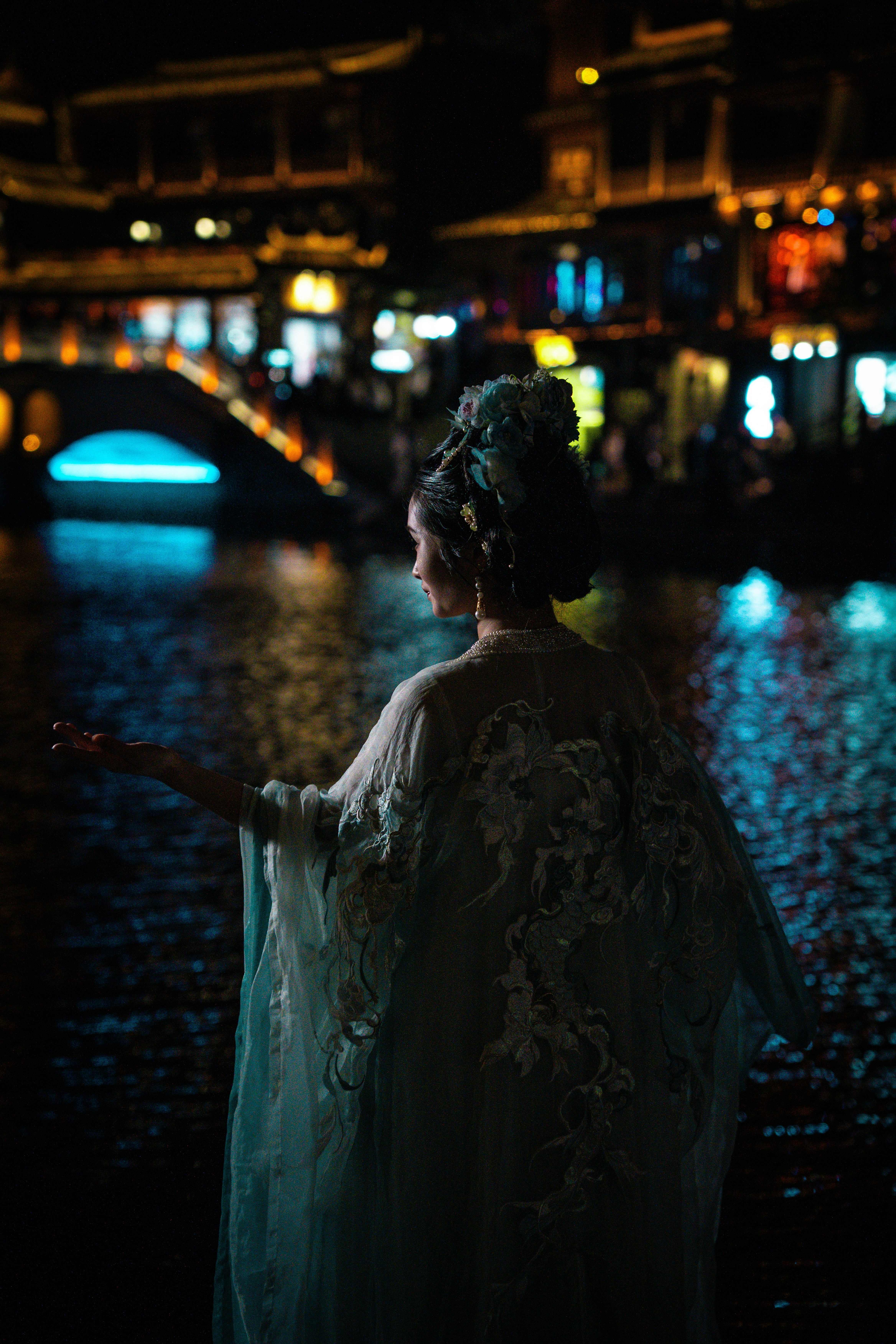 Woman in traditional dress poses by illuminated water. photo – Free ...