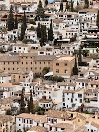 White buildings fill a densely packed hillside.