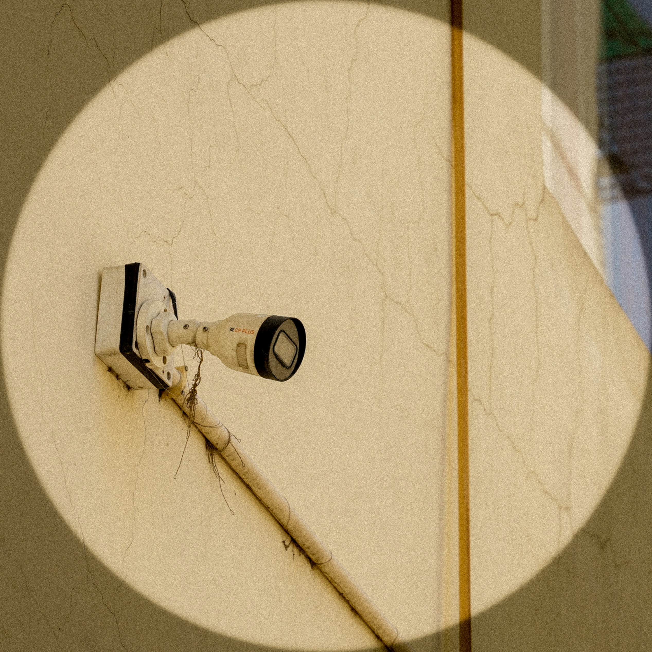 Security camera attached to an exterior wall.