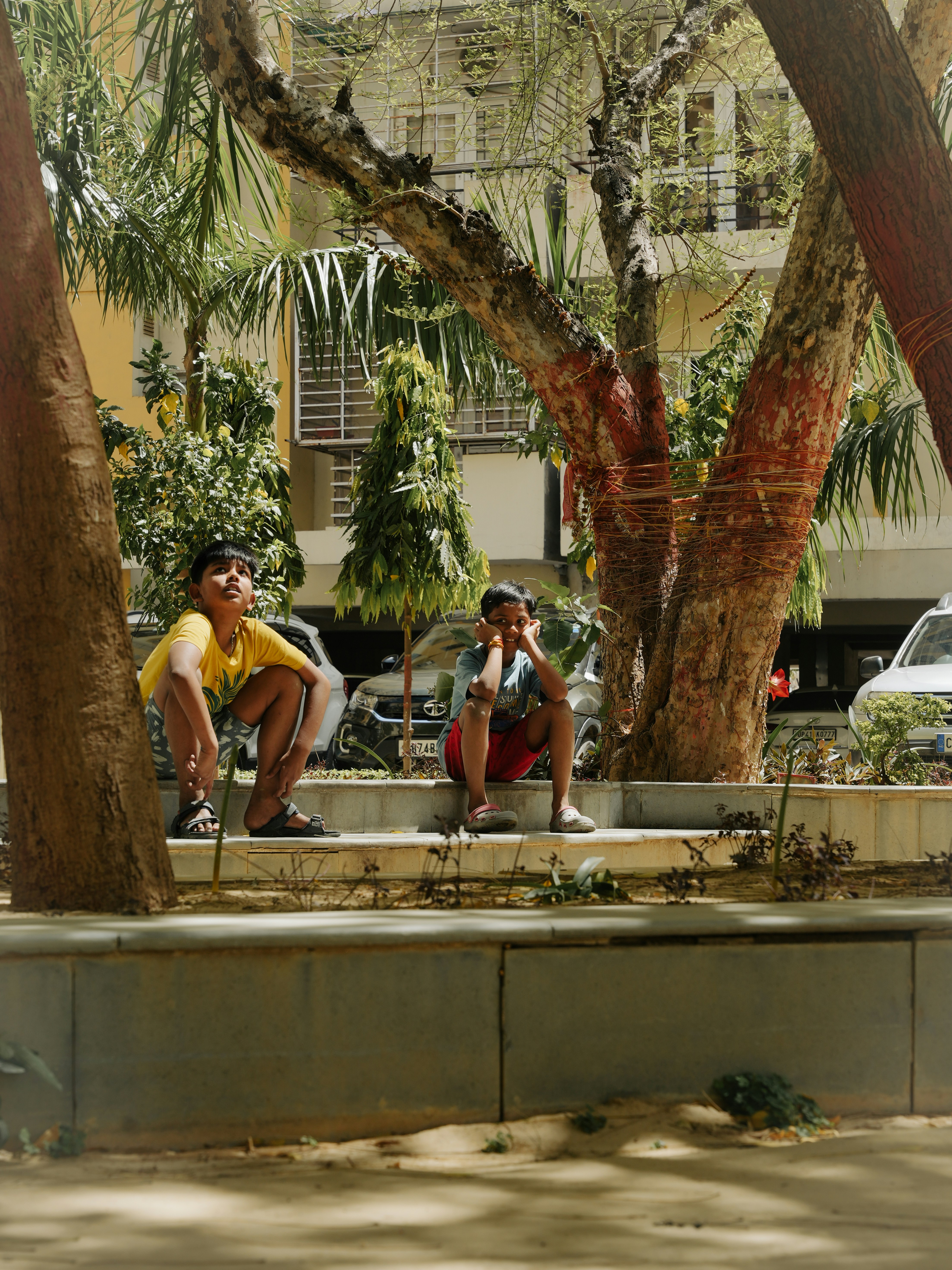 Two boys are sitting in the park.