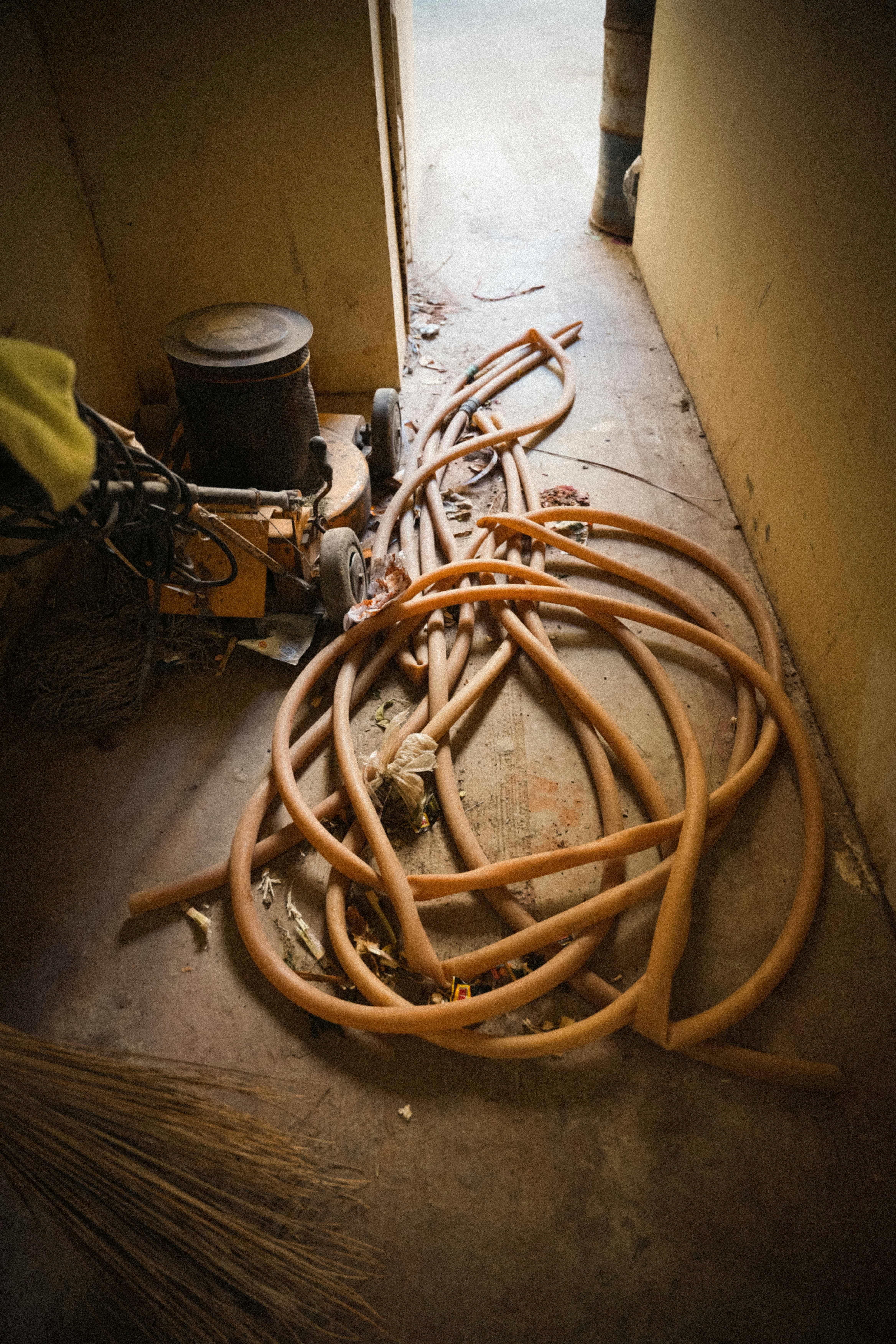 A pile of hoses and equipment in a doorway.