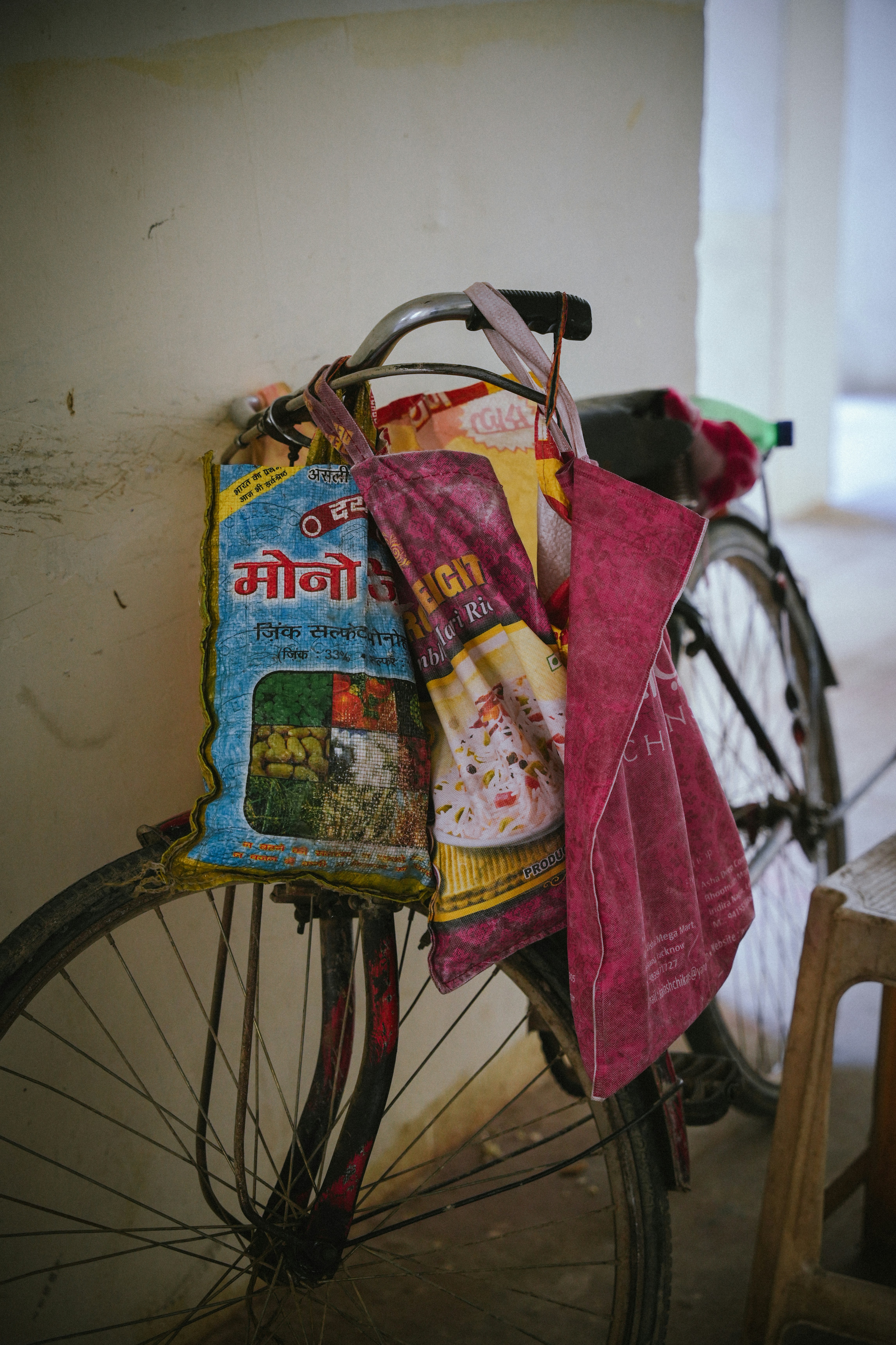 Bags hang from a bike's handlebars.