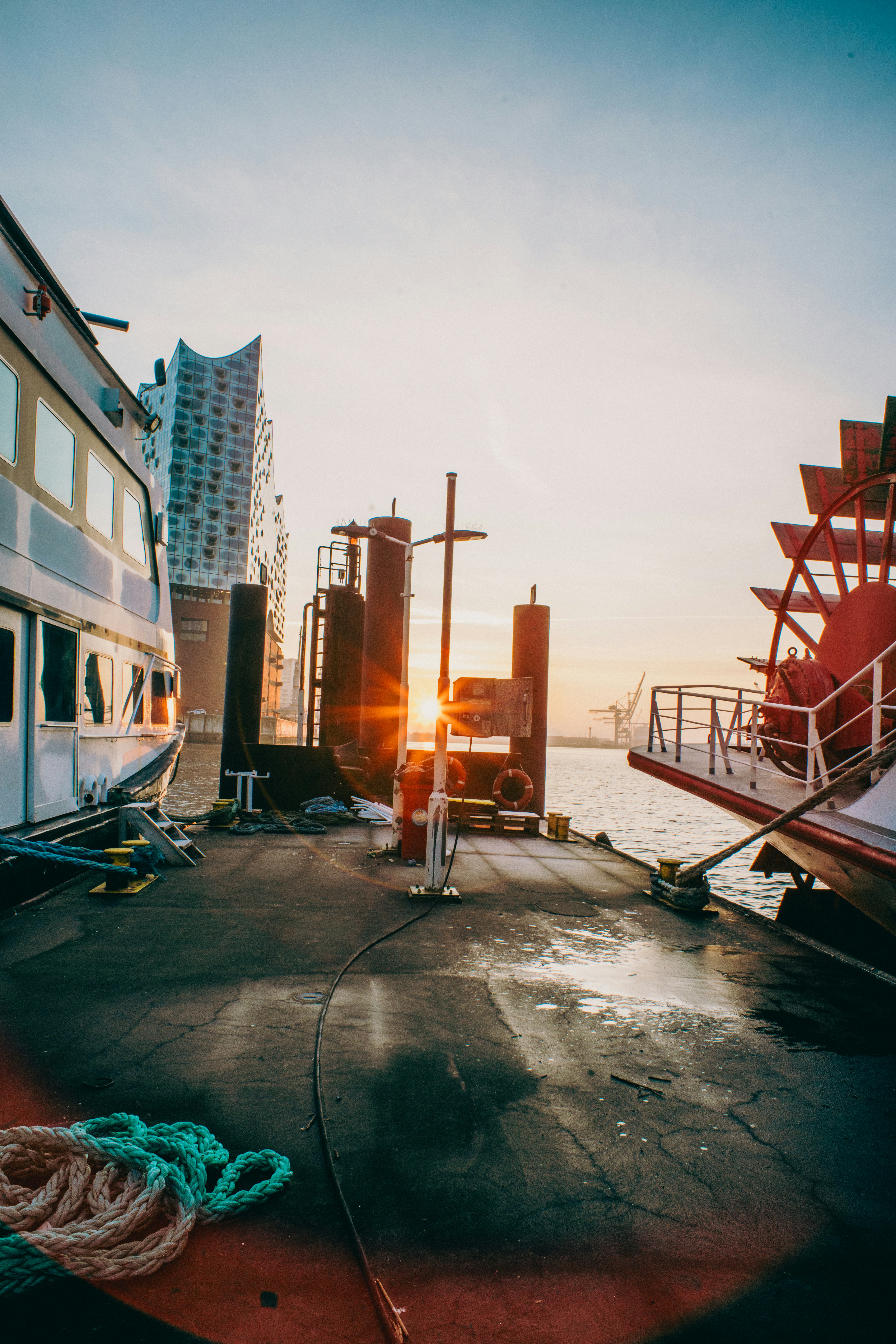 Sunset over a harbor with boats.