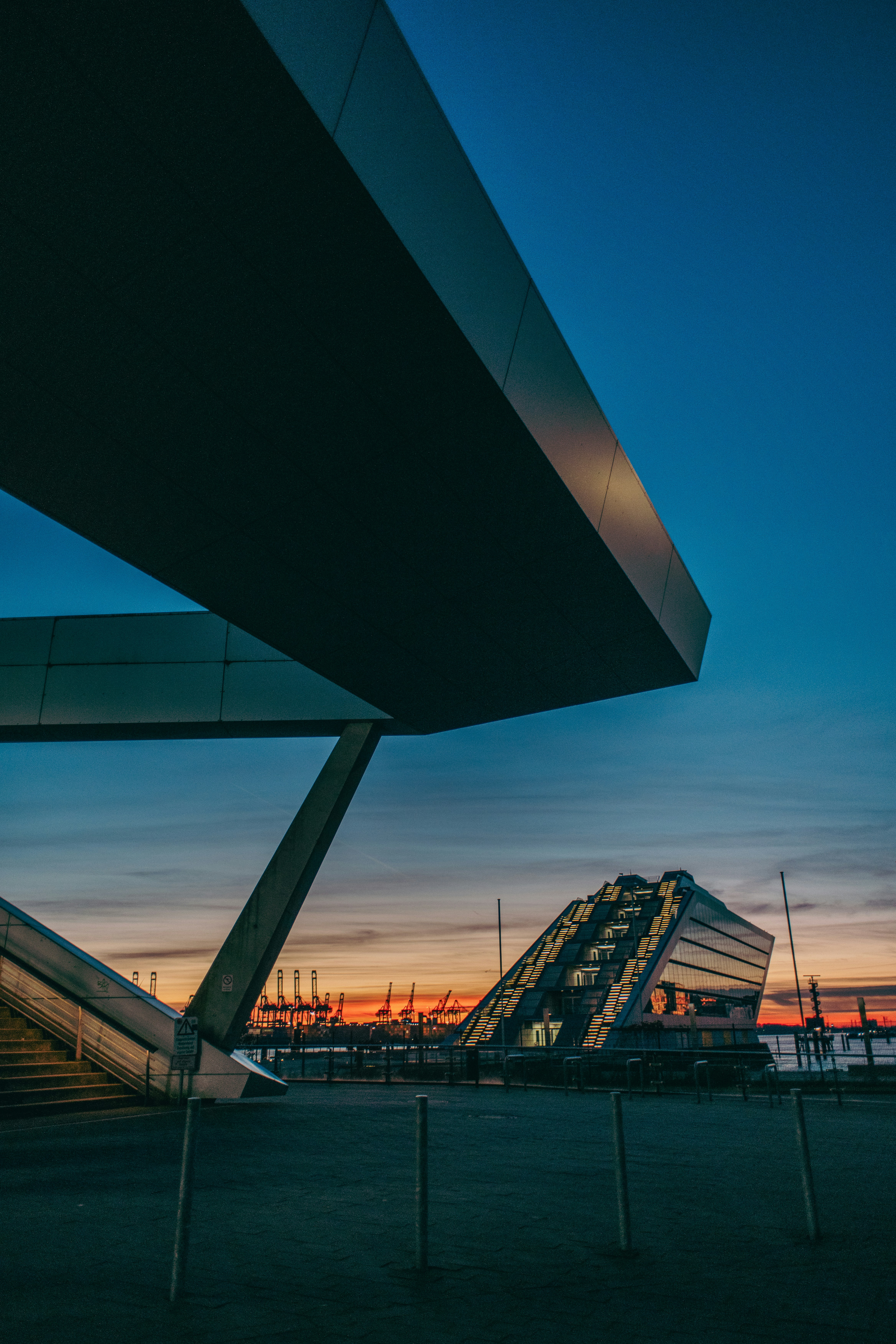 Modern architecture is silhouetted against the evening sky.