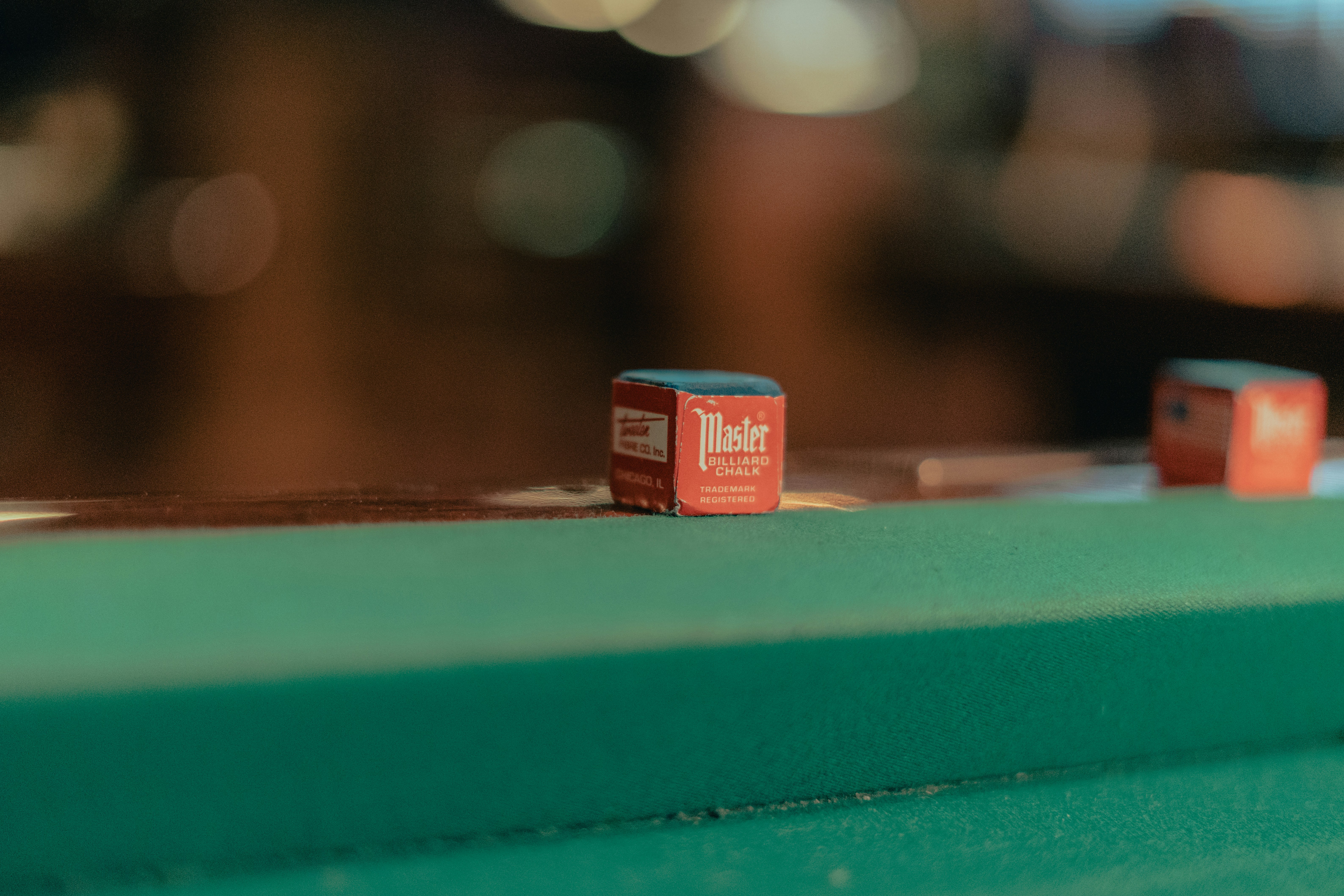 Two dice rest on a green table.
