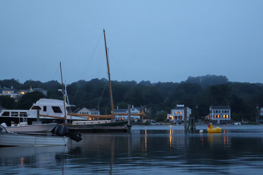 Boats in a New England harbor near the shoreline