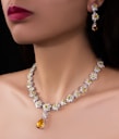 Elegant jewelry set adorns a woman's neck.