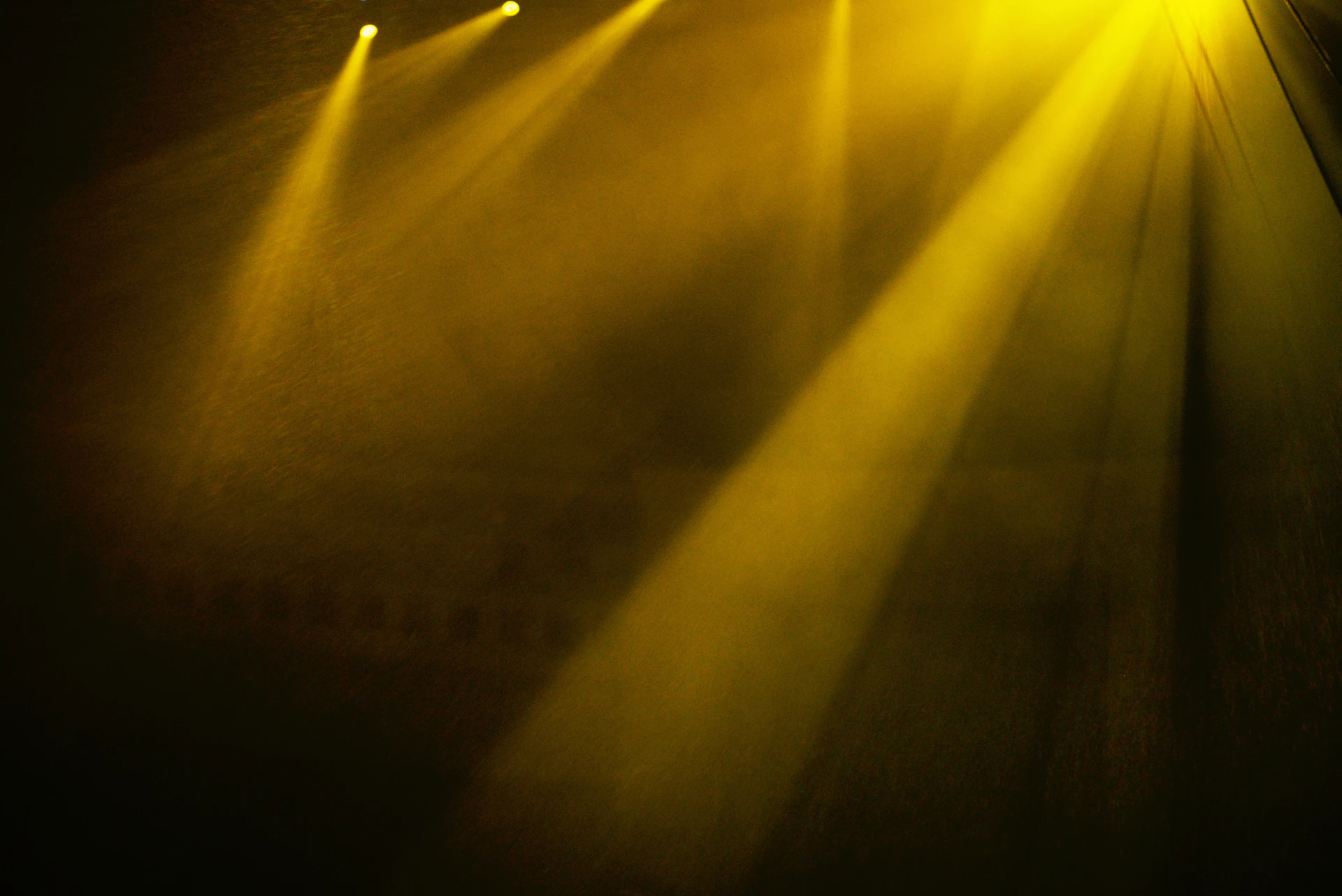 Yellow stage lights shining brightly from above.
