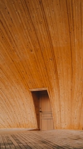 Wooden door framed in a wooden interior.