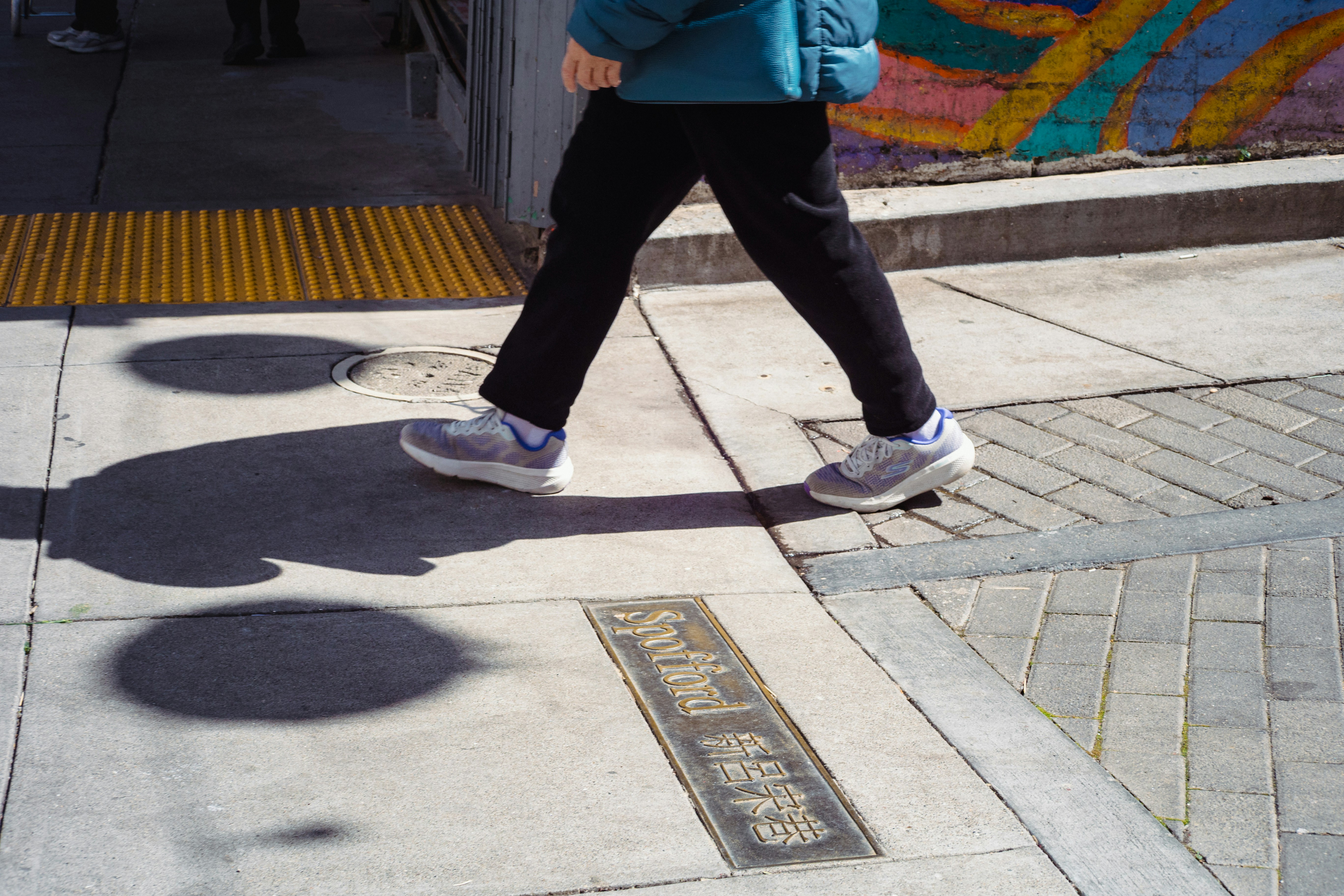 A person walks on a sidewalk.