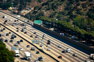 Cars are traveling along a busy multi-lane highway.