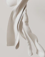 White fabric flows in a graceful, abstract way.