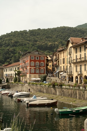 Boats docked in a quaint town by the water.