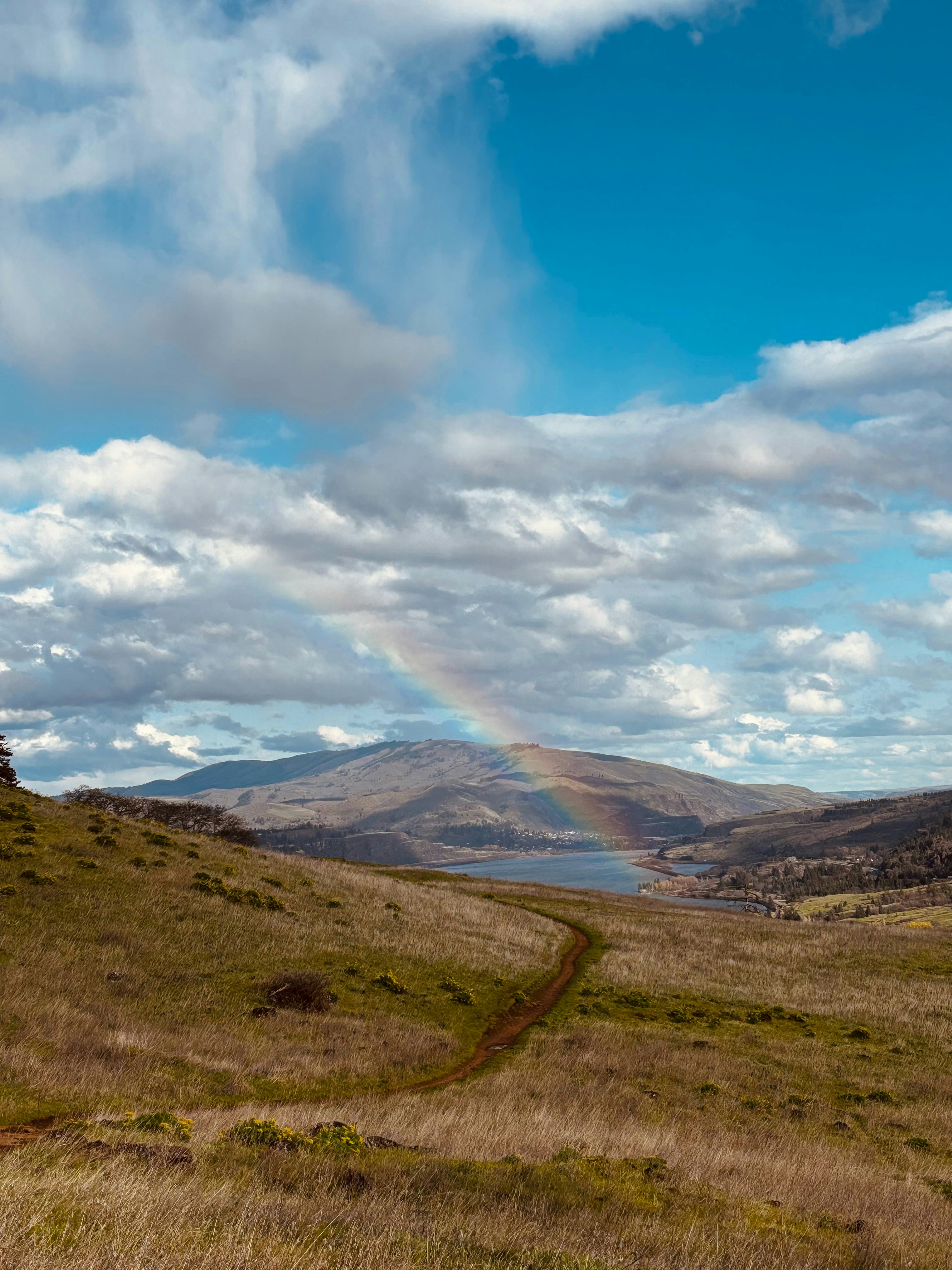 Rainbow arches over a beautiful landscape.