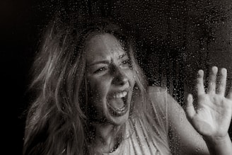 A woman screams in horror.