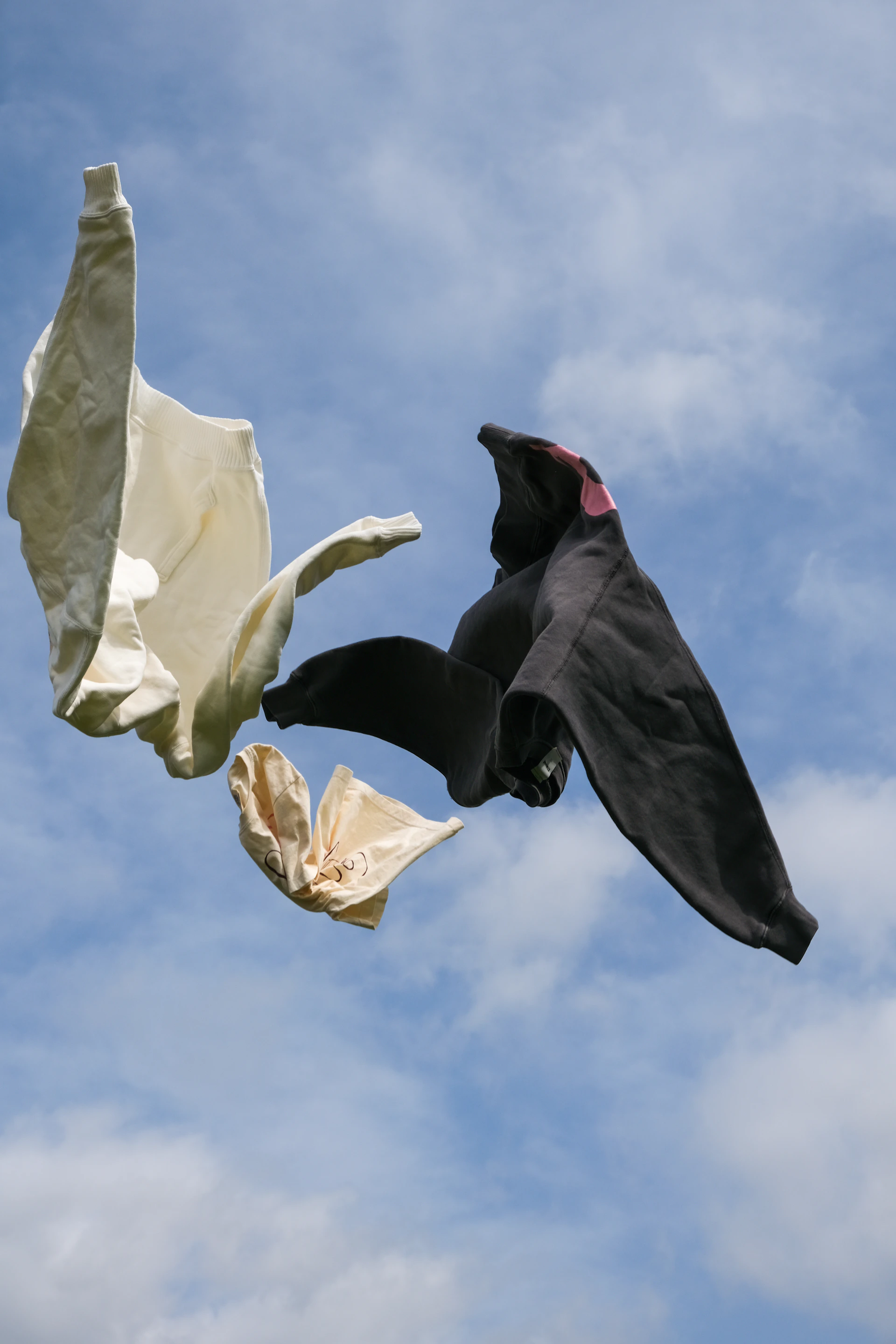 Clothes blow in the wind against a blue sky.