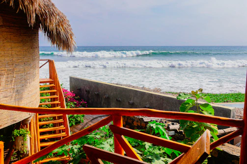 Wooden porch offers beautiful ocean view.