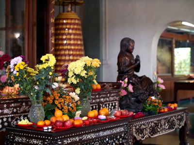 An ornate altar is set with flowers and fruit.