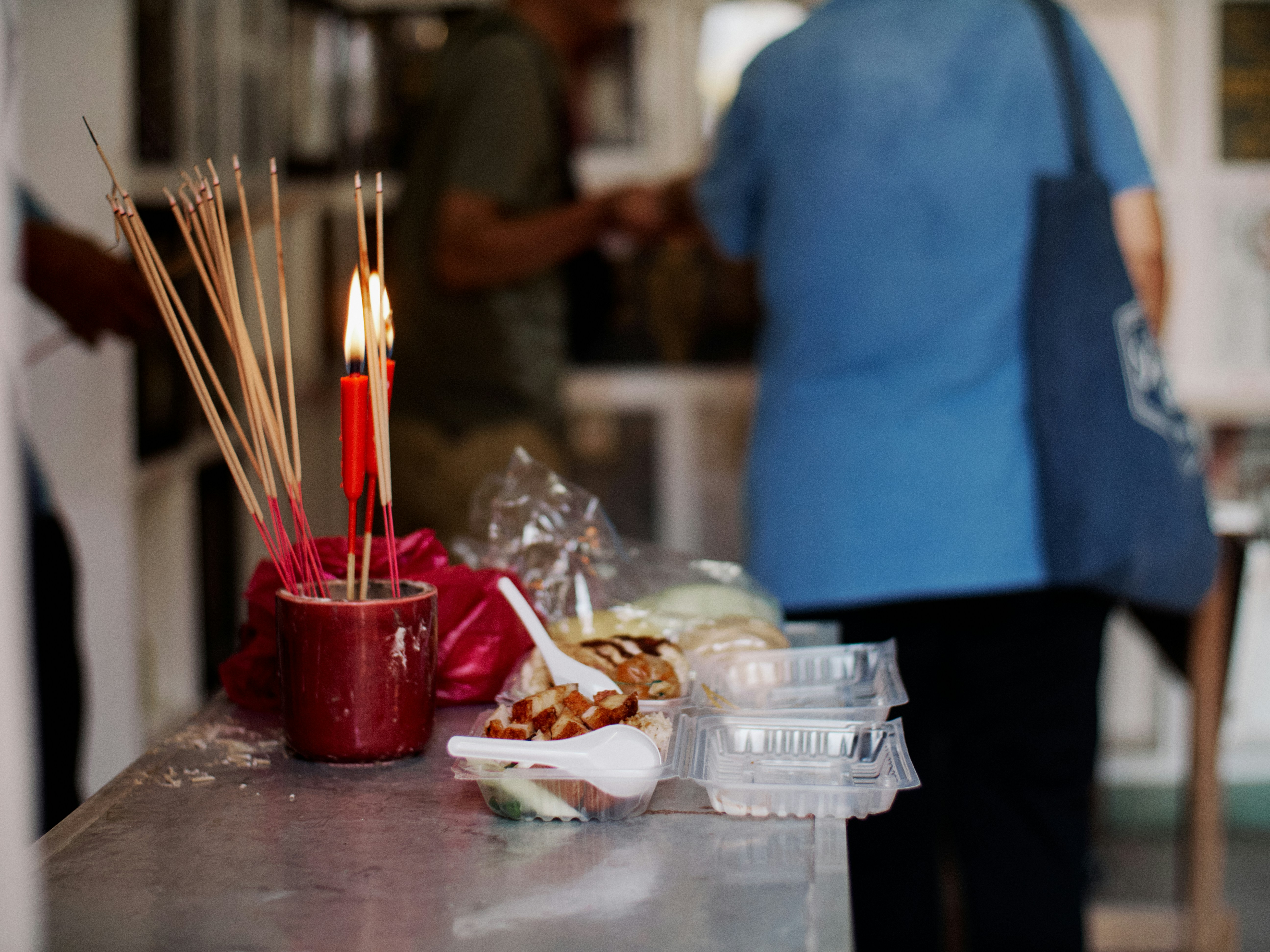 Incense and offerings are on a table.