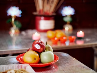 Fruits, candles, and incense create a spiritual offering.