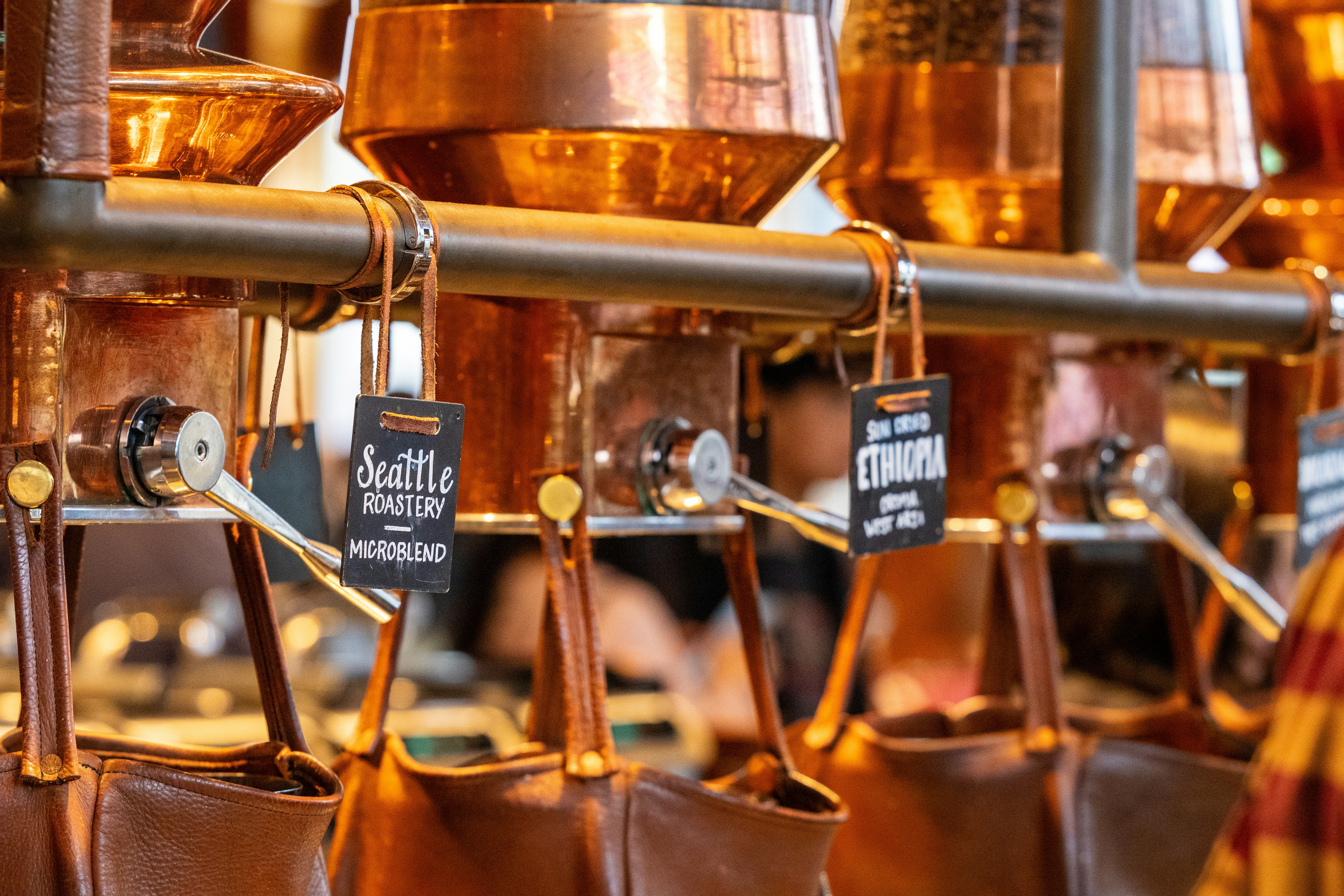 Coffee is dispensing from copper containers.