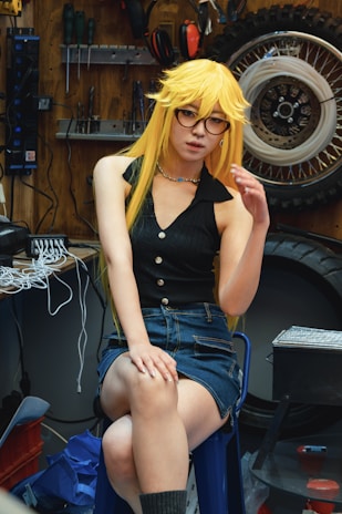 Cosplayer in a garage poses for a photo.
