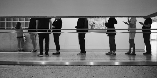 People are standing in a line, waiting.