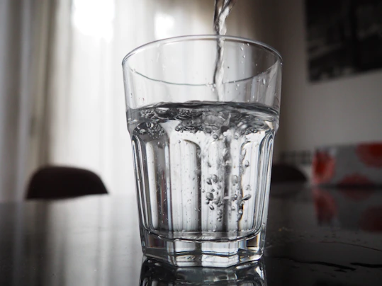 Water is being poured into a glass.