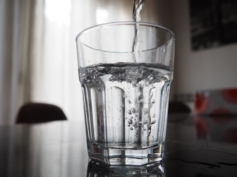 Fresh water being poured into a clear glass