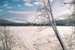Snowy landscape featuring a frozen lake and mountains