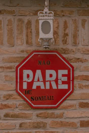Don't stop dreaming sign on a brick wall.
