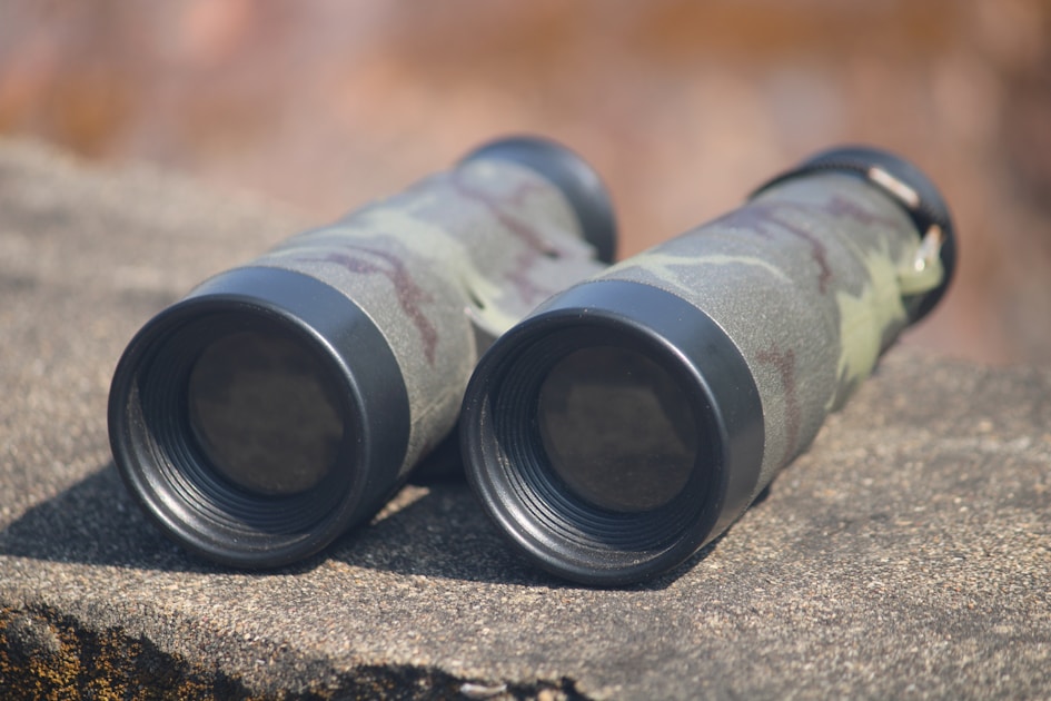 Hunter in treestand overlooking autumn forest trail