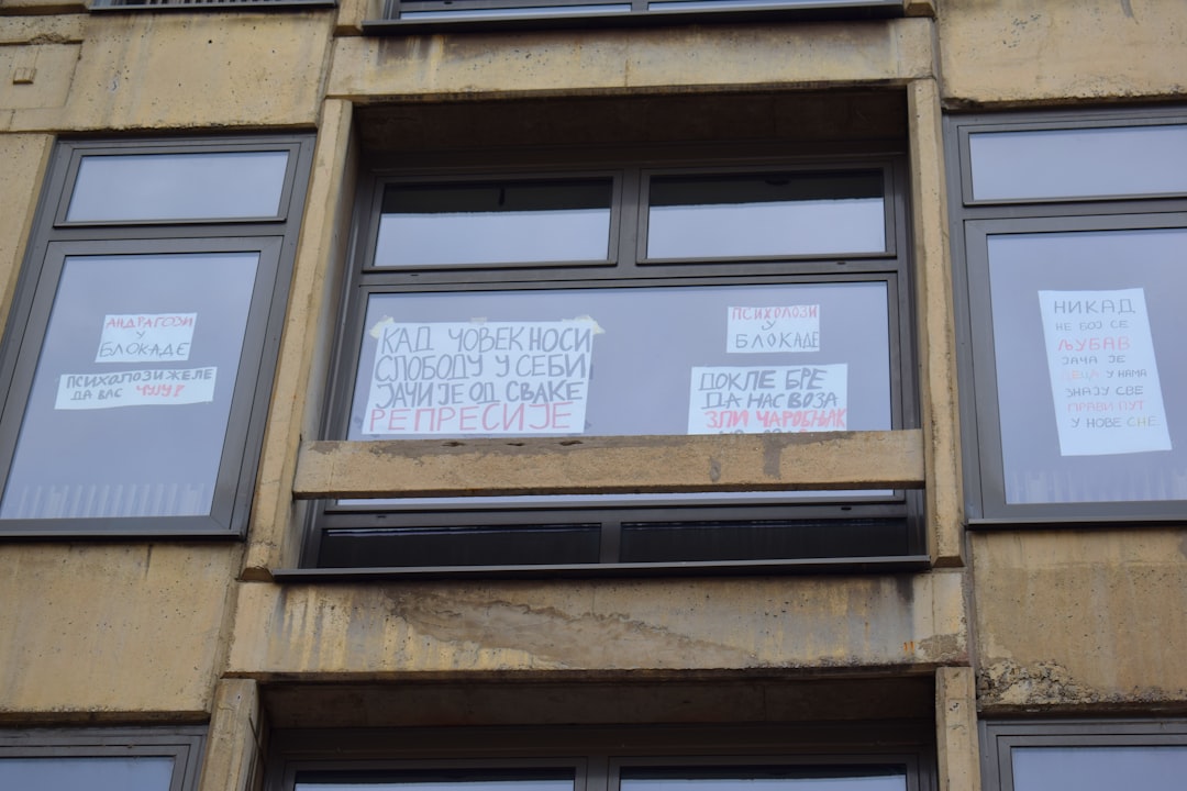 Windows of a building with posters in them.,