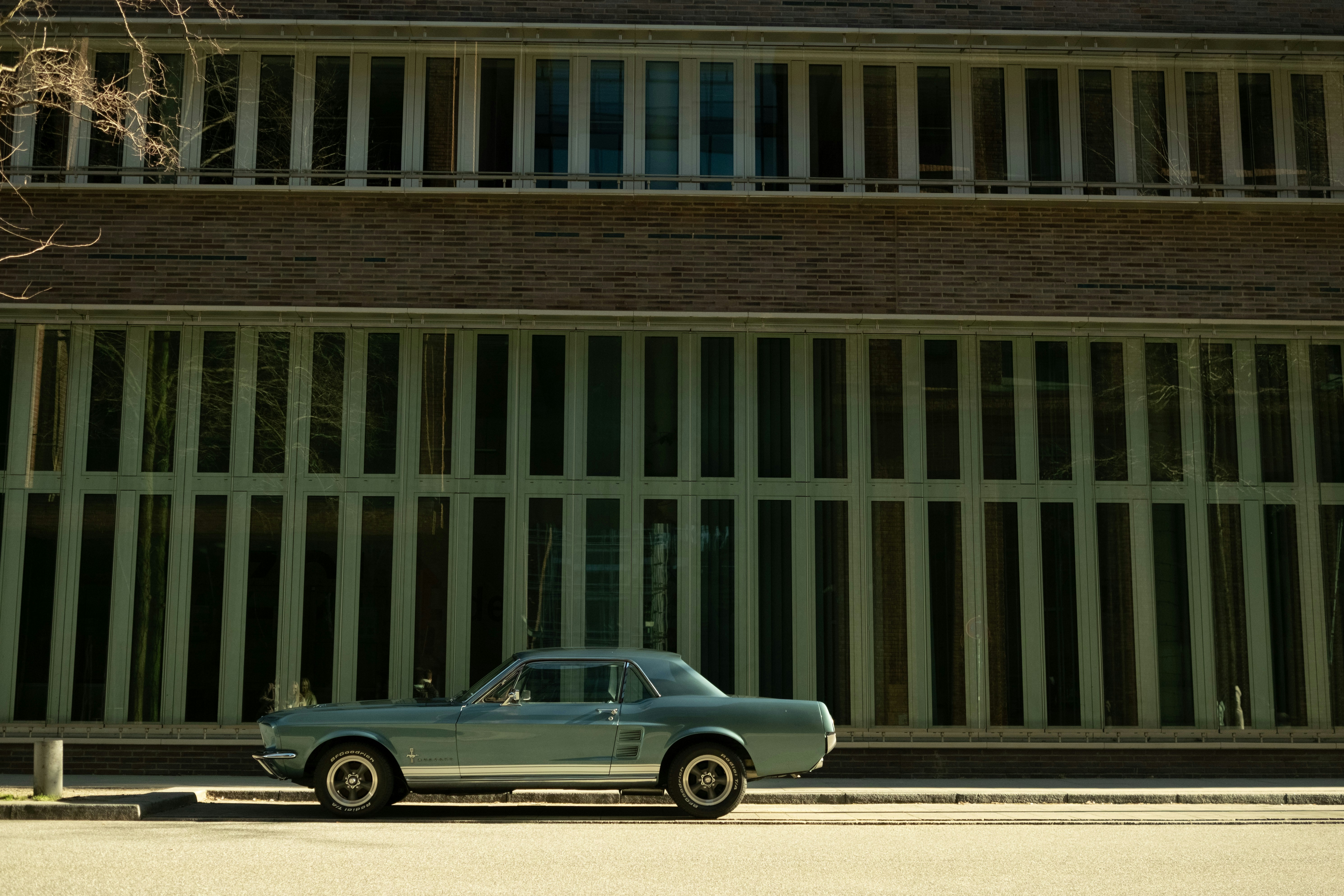 A classic car is parked in front of a building.