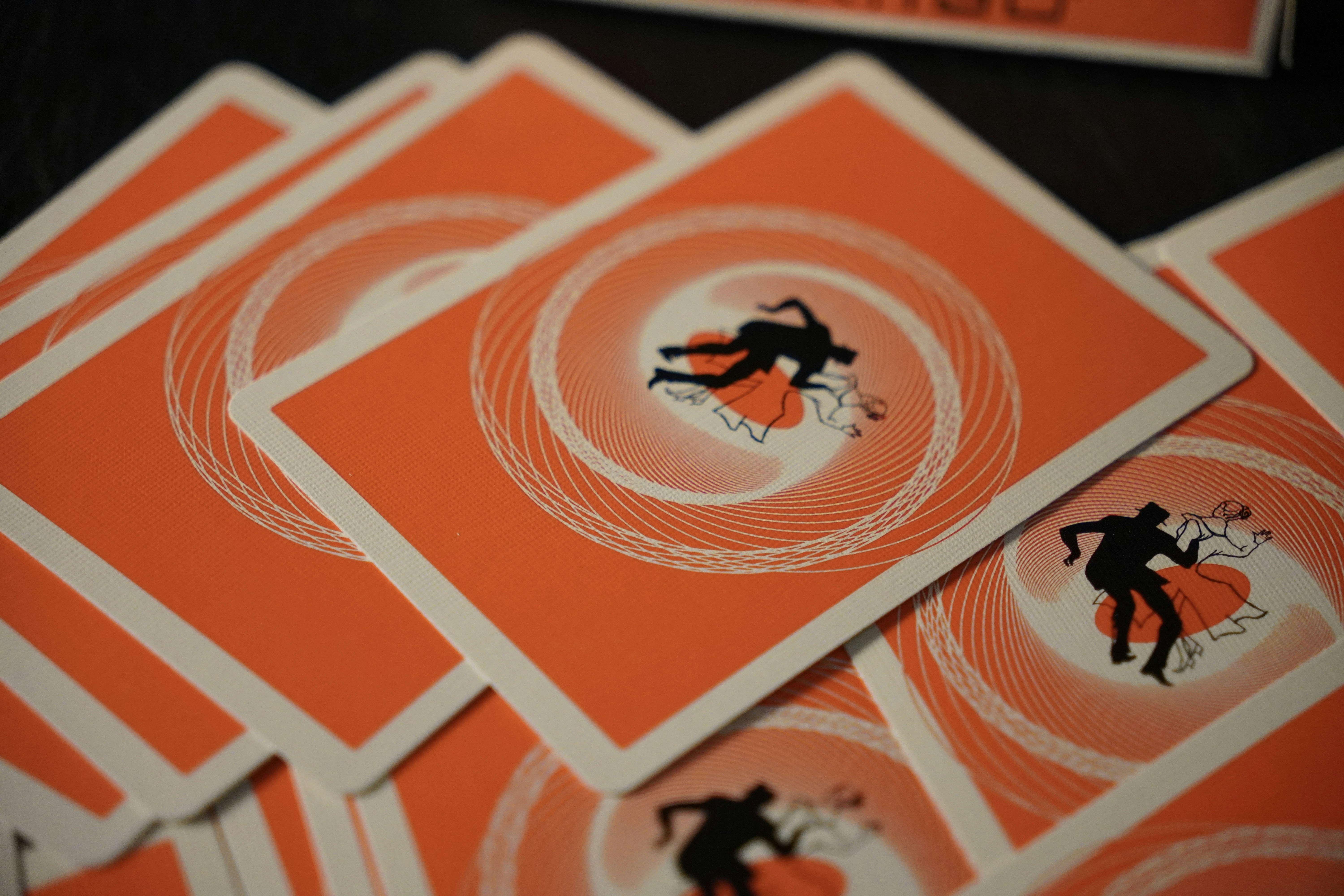 Playing cards with an orange design are displayed.