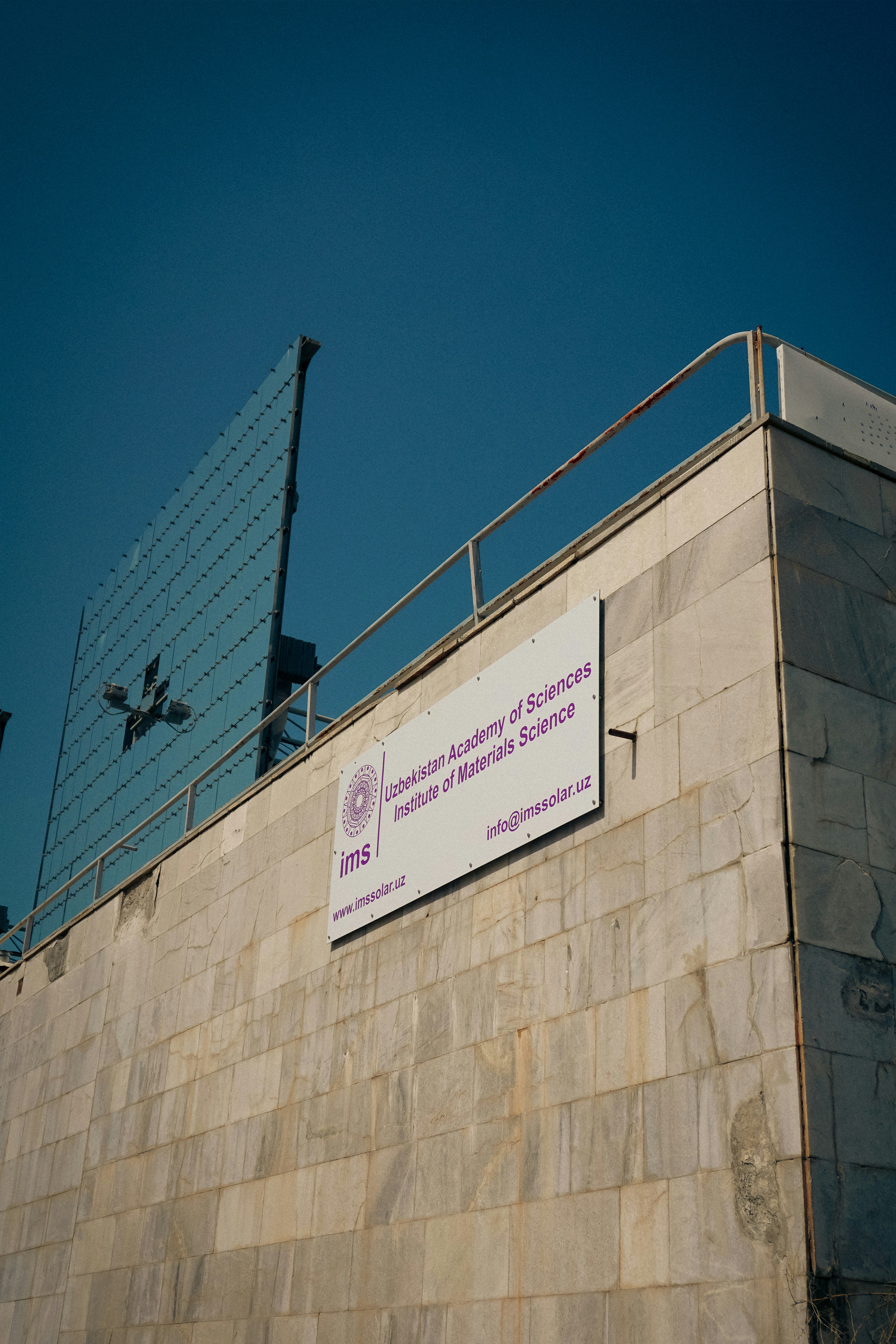 Sign and building under a blue sky.