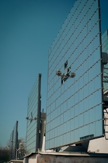 Solar panels shine brightly against a clear blue sky.