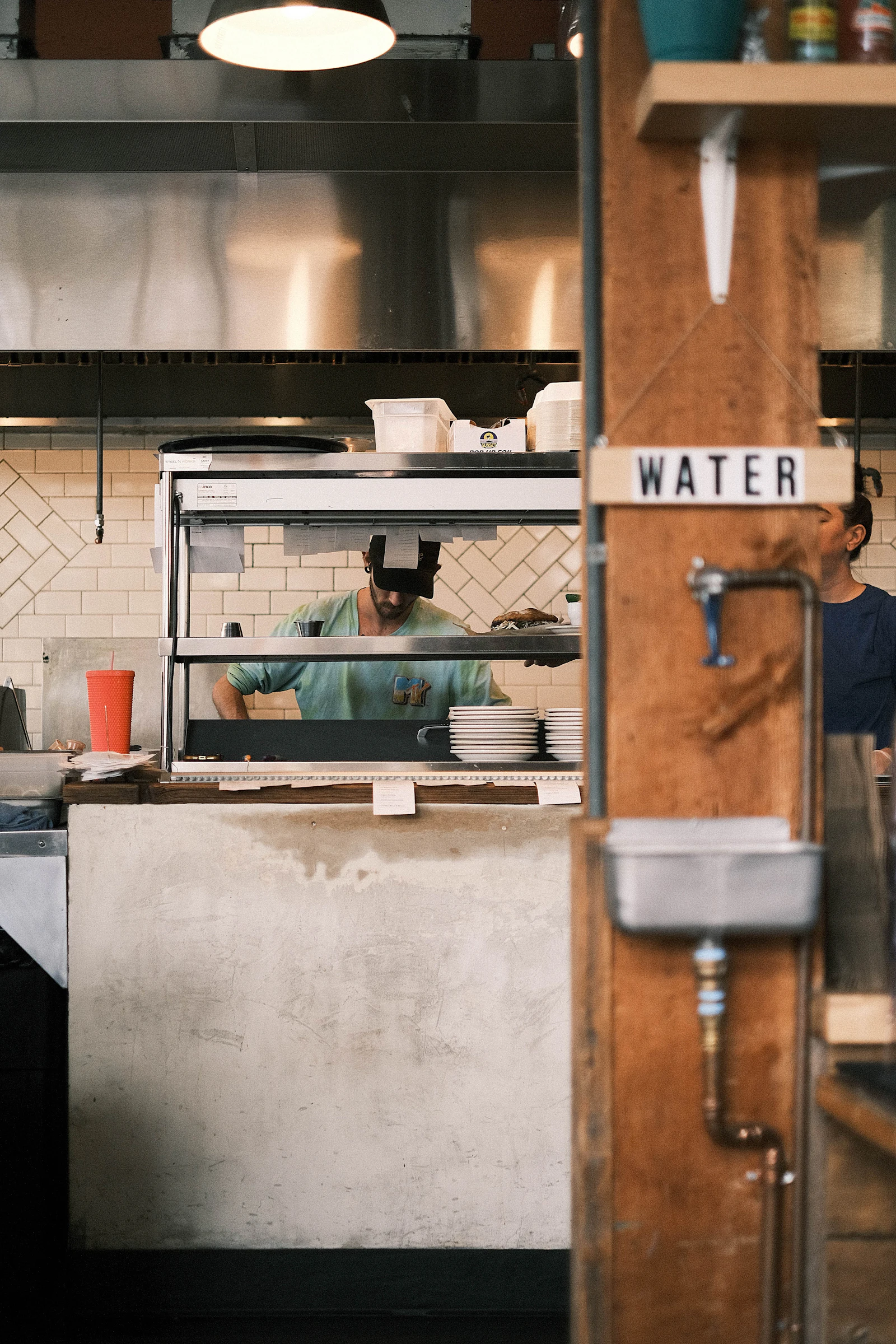 Kitchen team working along a planned equipment line during service