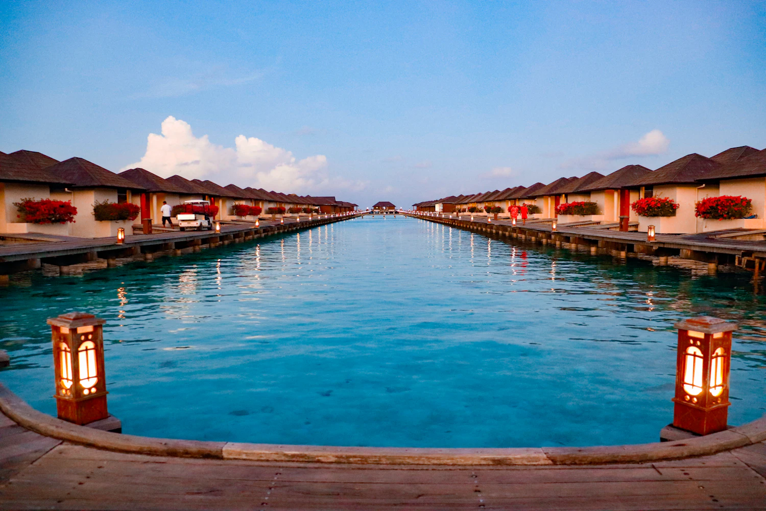 Two lines of overwater villas on a calm turquoise lagoon