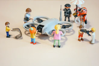 Playmobil figures are observing a drone