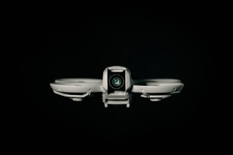 A drone faces the viewer against a black background.