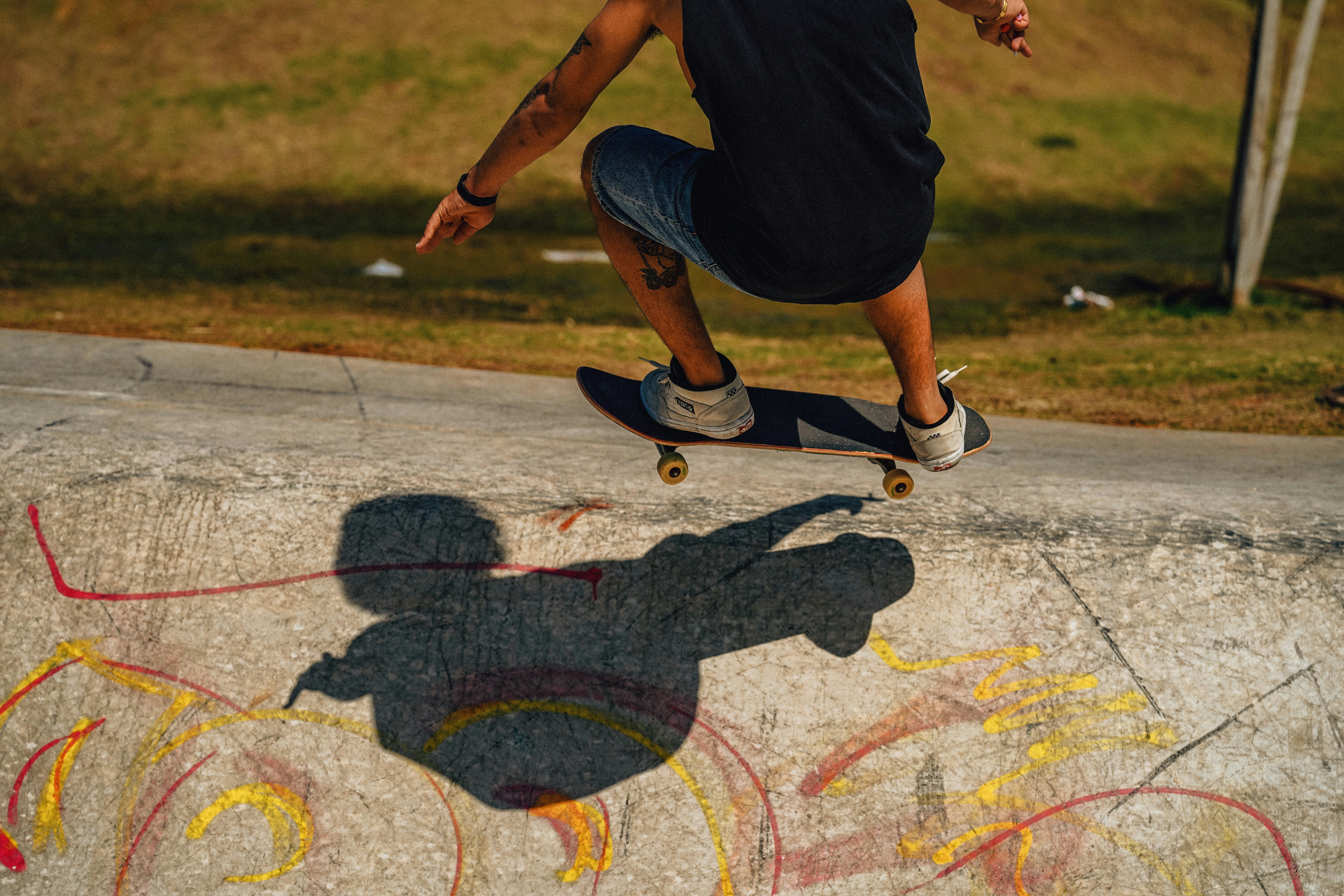 A skateboarder performs a trick in the park.